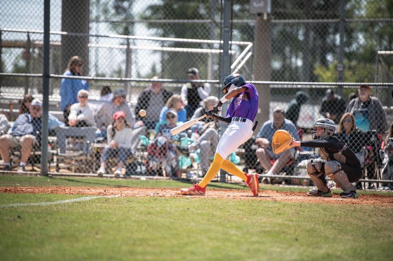 Young hitter extending the bat through contact